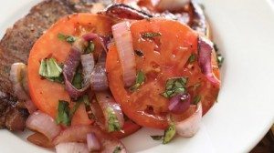 Who said salads have to be green? This one combines smoky onions with the juicy goodness of tomatoes and undoubtedly serves as a wonderful accompaniment to a grilled steak.