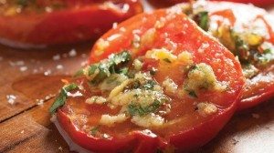 There’s only one thing that could make fresh, homegrown tomatoes better and that’s garlic. Serve them with a rice or grain dish, alongside grilled meats or with a thick slice of grilled bread to sop up the wonderful juices.