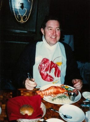 Kenny Walter smiling while having lobster meal