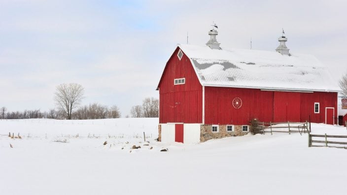 red barn in snow stock photo